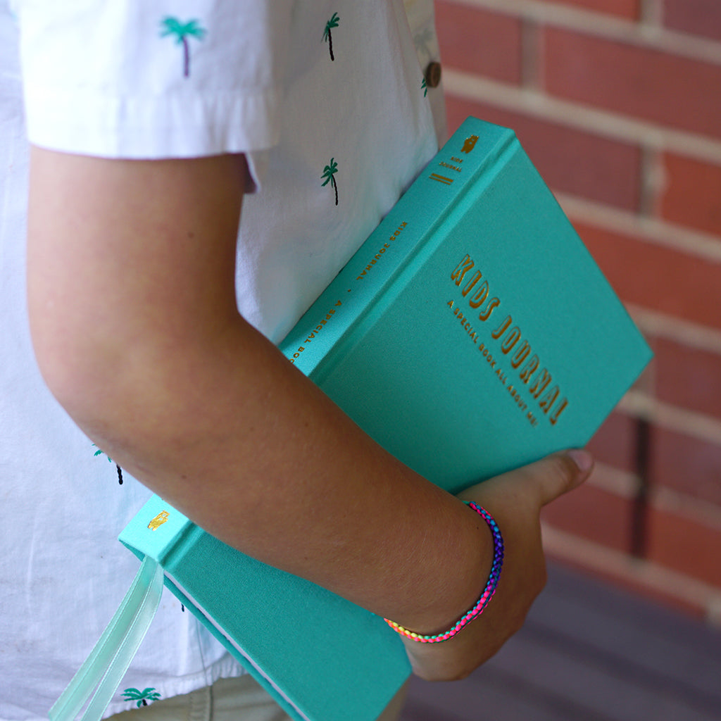 truly amor kids boy holding aqua dream kids journal